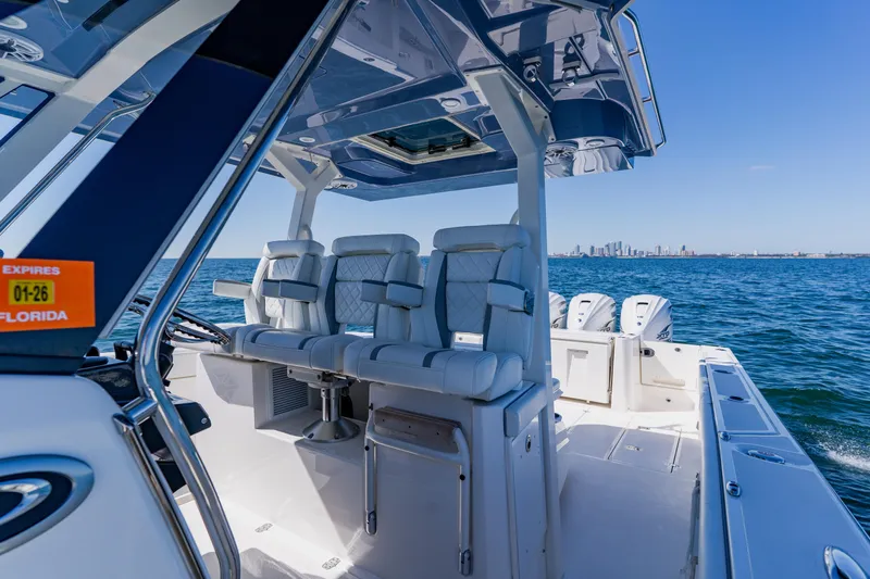 Blue Skies Yacht Photos Pics 2022 Pursuit S 378 Sport boat interior with city skyline in the background.
