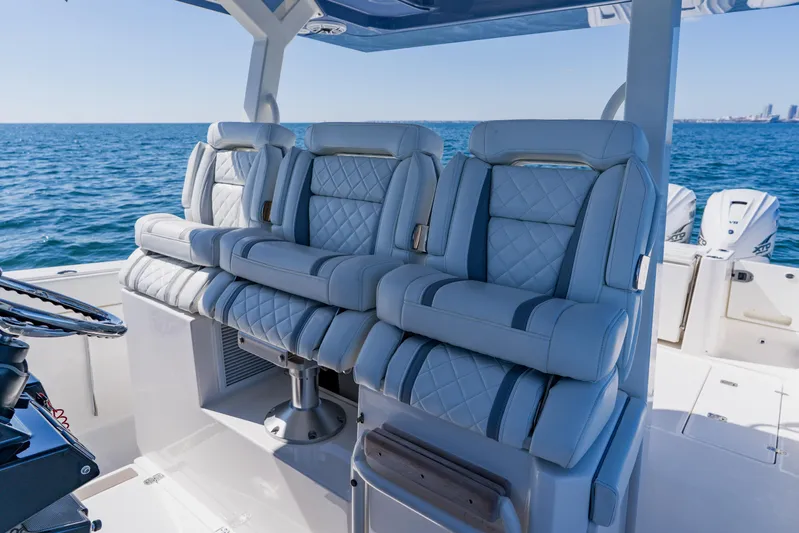 Blue Skies Yacht Photos Pics Luxurious seating on 2022 Pursuit S 378 Sport boat, ocean backdrop.