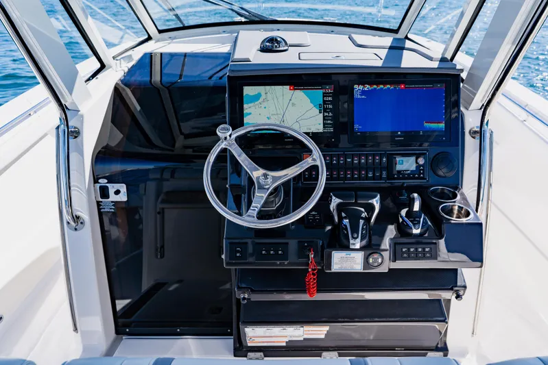 Blue Skies Yacht Photos Pics 2022 Pursuit S 378 Sport boat helm with advanced navigation and control systems.