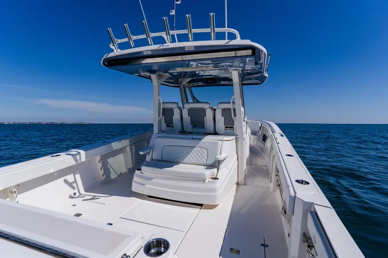 Blue Skies Yacht Photos Pics 2022 Pursuit S 378 Sport boat on open water, showcasing sleek design and spacious deck.