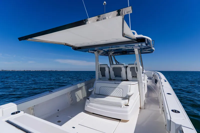 Blue Skies Yacht Photos Pics 2022 Pursuit S 378 Sport boat on open water, featuring spacious seating and sleek design.