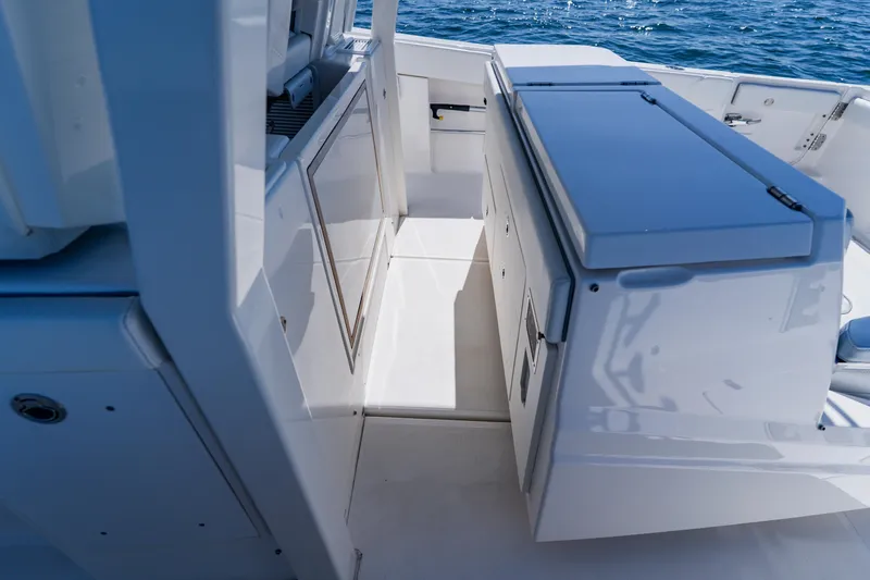 Blue Skies Yacht Photos Pics 2022 Pursuit S 378 Sport boat interior with sleek cabinetry and ocean view.