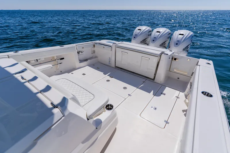 Blue Skies Yacht Photos Pics 2022 Pursuit S 378 Sport boat with triple engines on open sea.