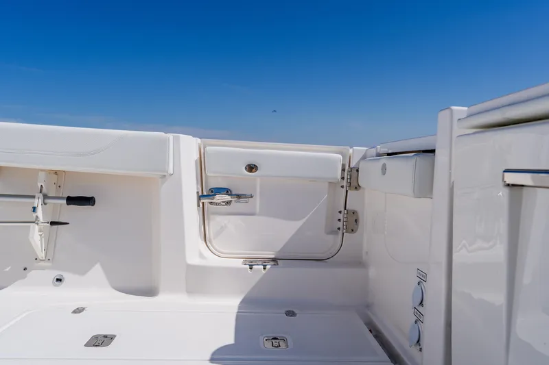 Blue Skies Yacht Photos Pics 2022 Pursuit S 378 Sport boat interior with white seating and storage compartments.