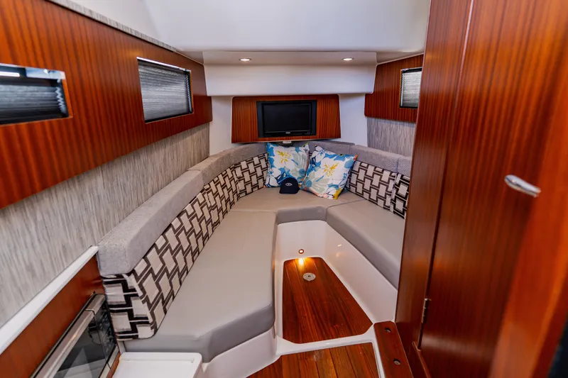 Blue Skies Yacht Photos Pics Luxurious interior of 2022 Pursuit S 378 Sport boat with cozy seating and modern decor.