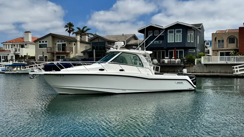  Yacht Photos Pics 2008 Boston Whaler 345 Conquest boat docked near waterfront homes.
