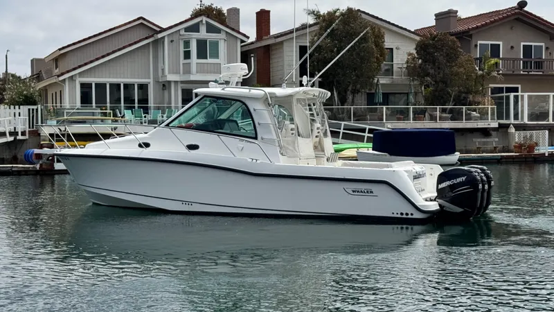  Yacht Photos Pics 2008 Boston Whaler 345 Conquest boat docked near waterfront homes.