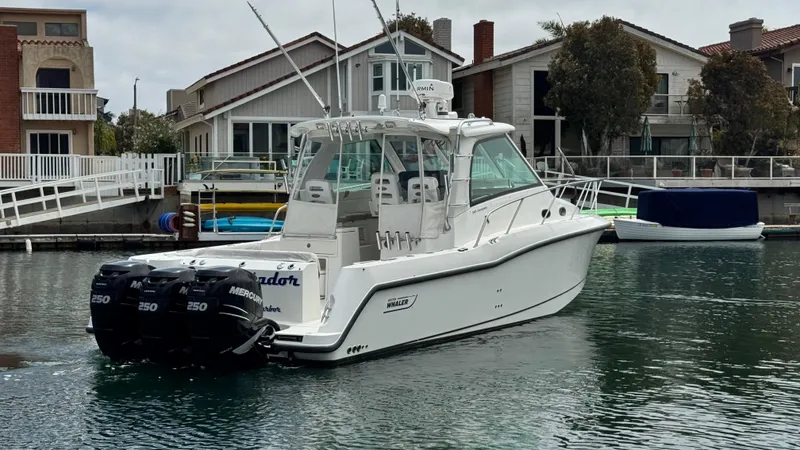  Yacht Photos Pics 2008 Boston Whaler 345 Conquest boat with triple Mercury engines in a marina setting.