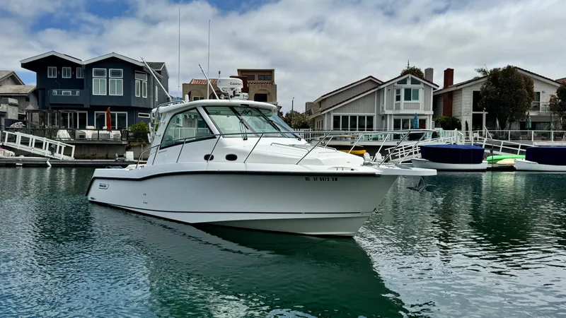  Yacht Photos Pics 2008 Boston Whaler 345 Conquest boat docked near waterfront homes.