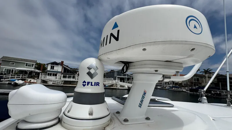  Yacht Photos Pics Radar and FLIR systems on a 2008 Boston Whaler 345 Conquest boat, docked near waterfront homes.