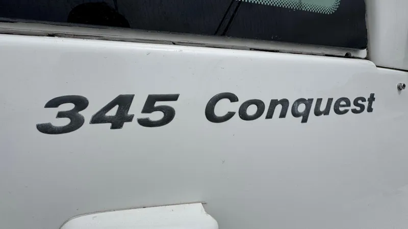  Yacht Photos Pics 2008 Boston Whaler 345 Conquest boat nameplate on white surface.