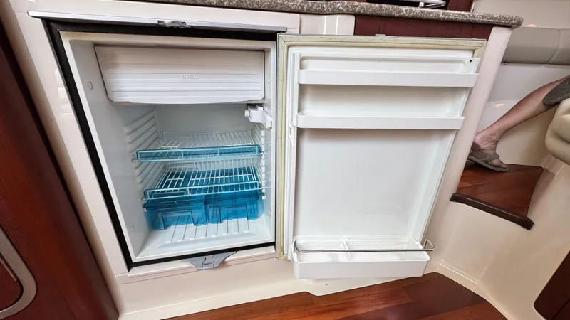  Yacht Photos Pics Open refrigerator on 2008 Boston Whaler 345 Conquest boat, showing interior shelves and storage.
