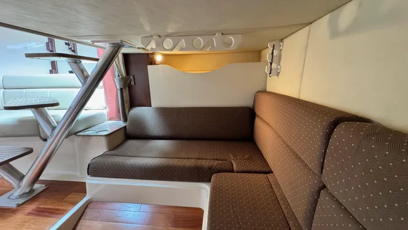  Yacht Photos Pics 2008 Boston Whaler 345 Conquest cabin interior with brown seating and wooden flooring.