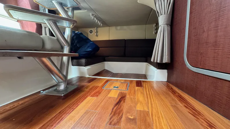  Yacht Photos Pics Interior of 2008 Boston Whaler 345 Conquest with wood flooring and seating area.