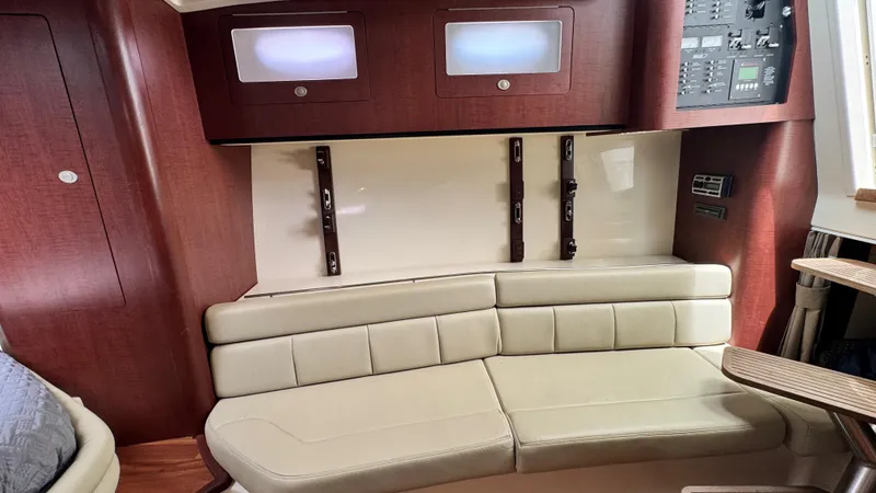  Yacht Photos Pics 2008 Boston Whaler 345 Conquest cabin interior with beige seating and control panel.