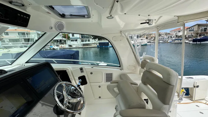  Yacht Photos Pics 2008 Boston Whaler 345 Conquest helm with luxurious seating and waterfront view.