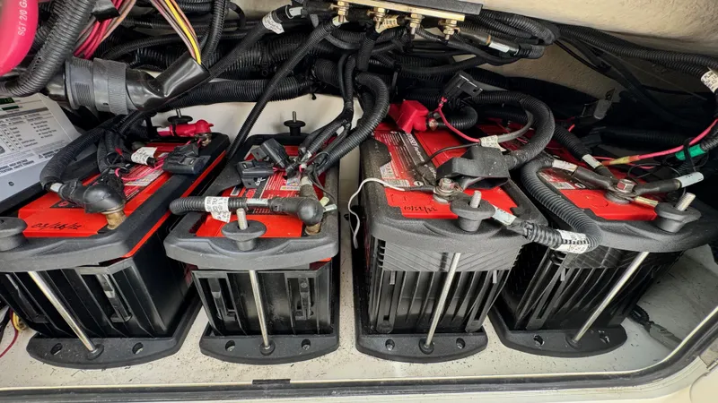  Yacht Photos Pics Battery compartment of a 2008 Boston Whaler 345 Conquest boat, showing multiple connected batteries.