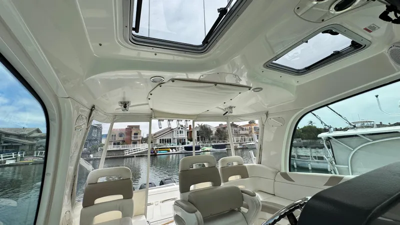  Yacht Photos Pics Interior view of 2008 Boston Whaler 345 Conquest boat with seating and windows.