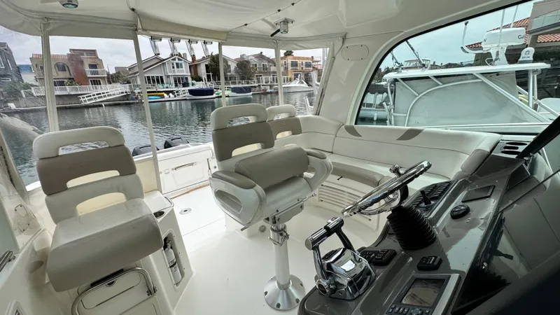  Yacht Photos Pics Interior view of 2008 Boston Whaler 345 Conquest boat, featuring helm and seating area.