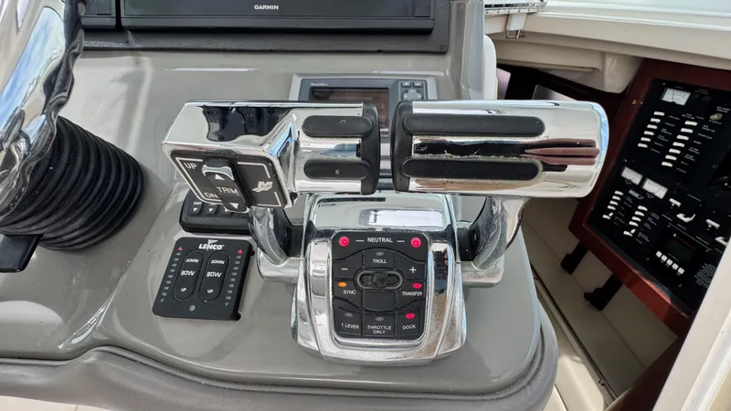  Yacht Photos Pics Control panel of a 2008 Boston Whaler 345 Conquest boat, featuring throttle and trim controls.