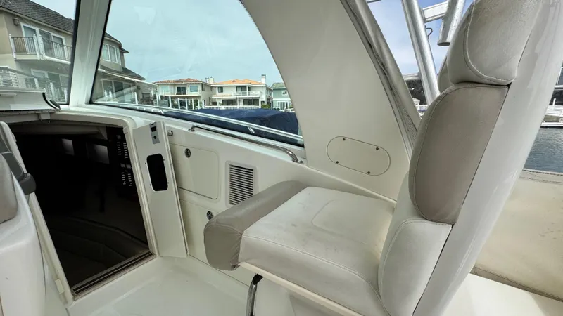  Yacht Photos Pics 2008 Boston Whaler 345 Conquest interior with helm seat and cabin view.