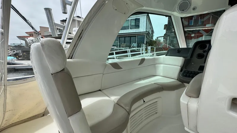  Yacht Photos Pics Interior of a 2008 Boston Whaler 345 Conquest boat with white seating and control panel.