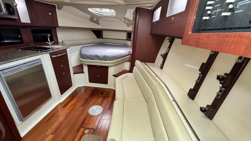 Yacht Photos Pics Interior of 2008 Boston Whaler 345 Conquest with bed, kitchenette, and seating area.