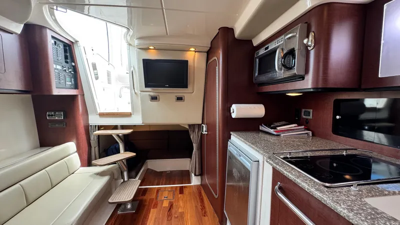  Yacht Photos Pics 2008 Boston Whaler 345 Conquest interior with kitchen, seating, and entertainment area.