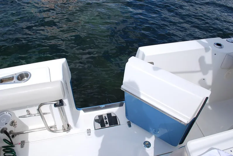  Yacht Photos Pics 2017 Boston Whaler 330 Outrage boat deck with open hatch, near water.