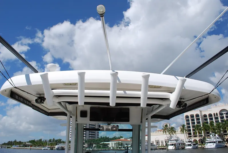  Yacht Photos Pics Boston Whaler 330 Outrage 2017 boat with rod holders, under a blue sky with clouds.