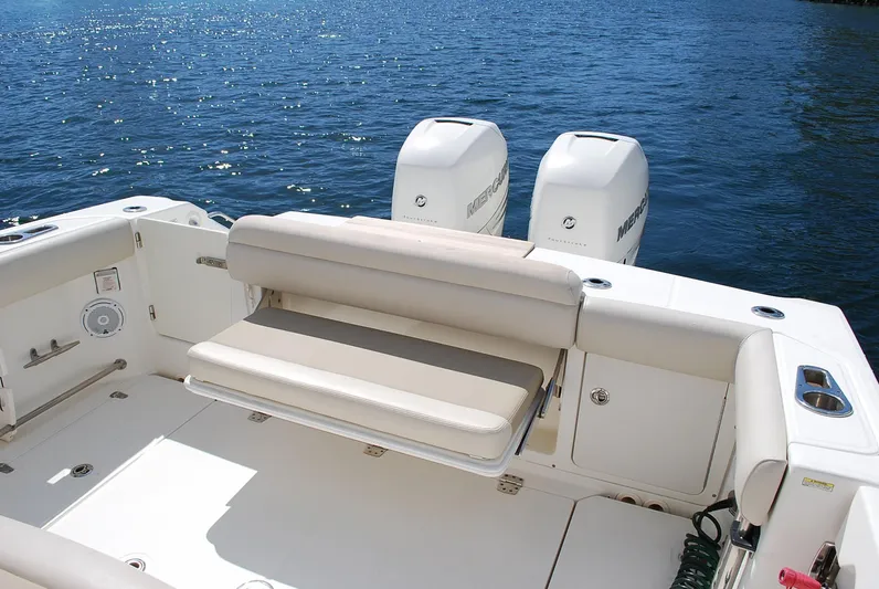  Yacht Photos Pics 2017 Boston Whaler 330 Outrage boat with dual Mercury engines on a sunny day.