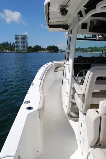  Yacht Photos Pics 2017 Boston Whaler 330 Outrage boat on water, sunny day, modern design.