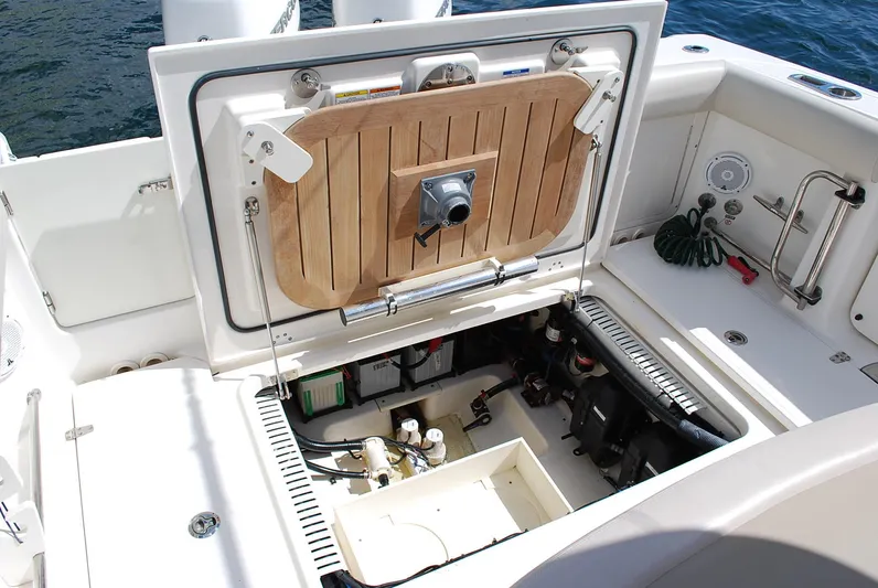  Yacht Photos Pics 2017 Boston Whaler 330 Outrage boat showing open hatch with engine components.