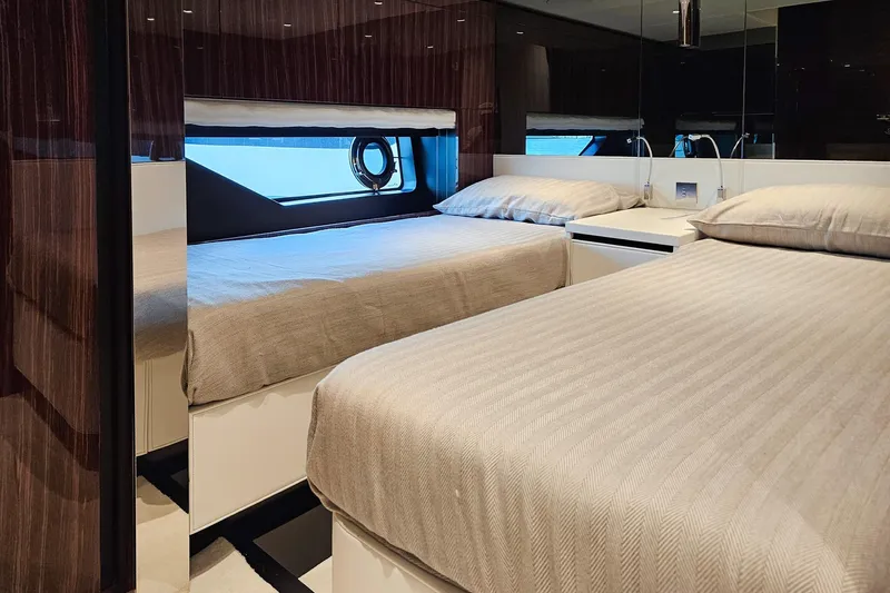  Yacht Photos Pics Luxurious twin bedroom on 2022 Riva 82' Diva yacht with elegant decor and ocean view.