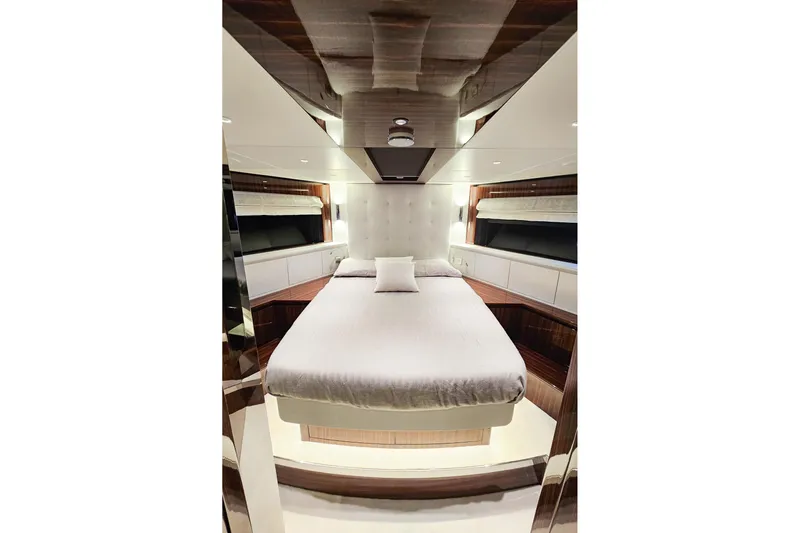  Yacht Photos Pics Luxurious bedroom interior of 2022 Riva 82' Diva yacht, featuring elegant design and plush bedding.