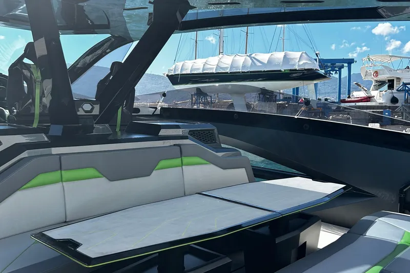  Yacht Photos Pics Interior view of 2026 Tecnomar 63 yacht with modern seating and marina backdrop.