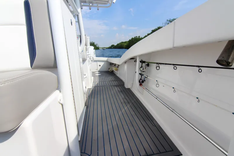  Yacht Photos Pics 1996 Ocean Master 31 Center Console boat interior with fishing rods and seating.