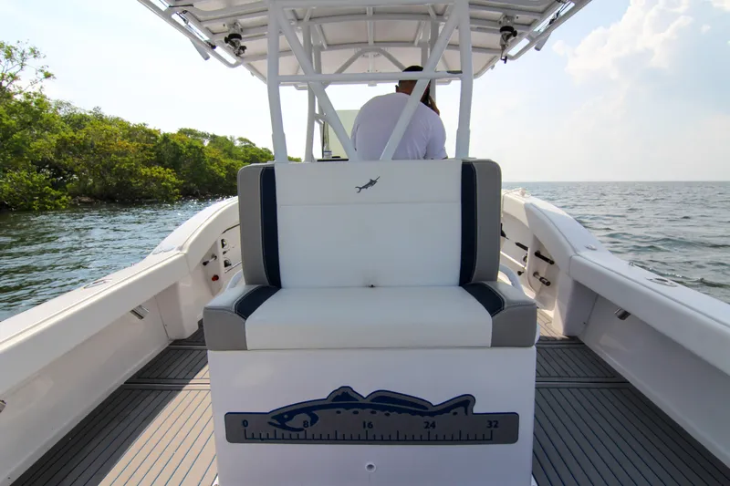  Yacht Photos Pics 1996 Ocean Master 31 Center Console boat on open water, featuring sleek seating and modern design.
