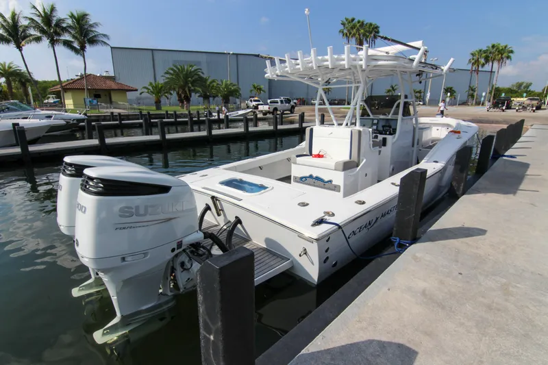  Yacht Photos Pics 1996 Ocean Master 31 Center Console boat docked with twin Suzuki engines.
