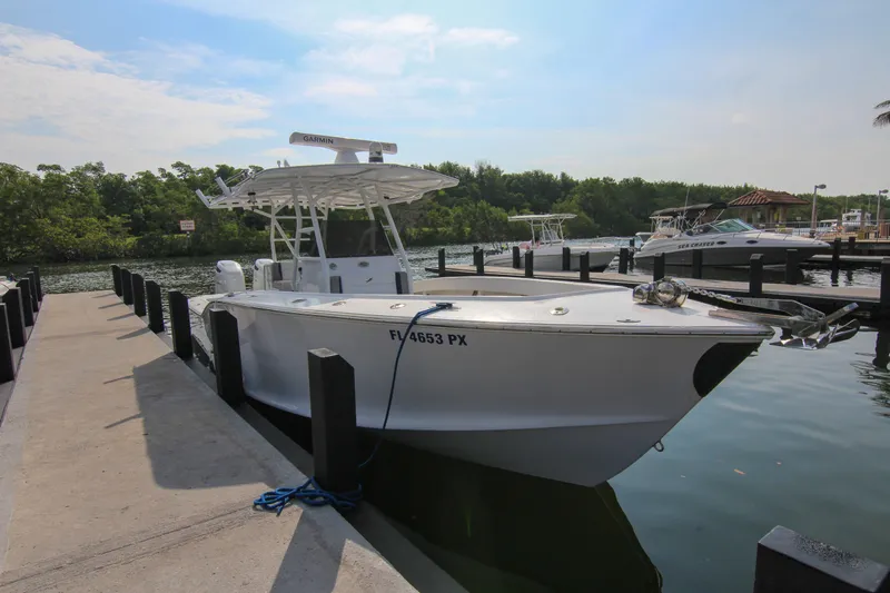  Yacht Photos Pics 1996 Ocean Master 31 Center Console boat docked at a marina.