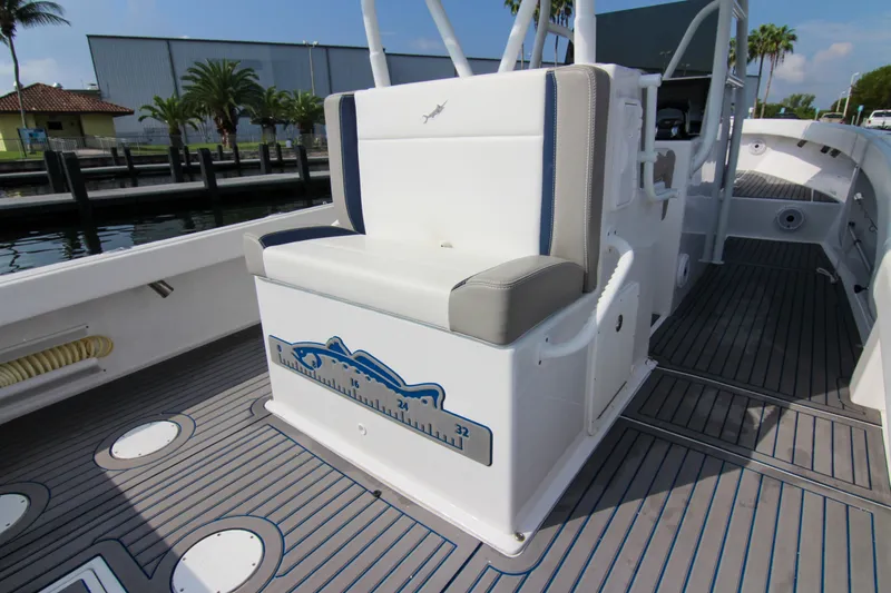  Yacht Photos Pics 1996 Ocean Master 31 Center Console boat interior with cushioned seating and measuring scale.