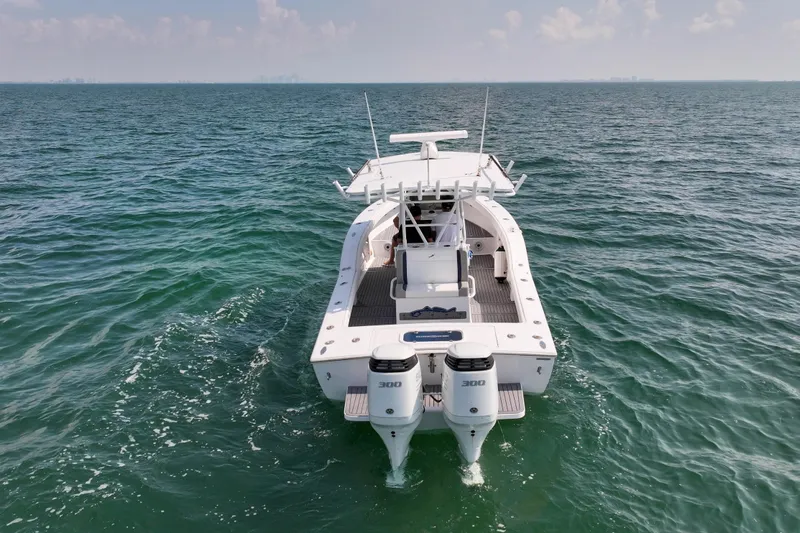  Yacht Photos Pics 1996 Ocean Master 31 Center Console boat on open water, rear view.