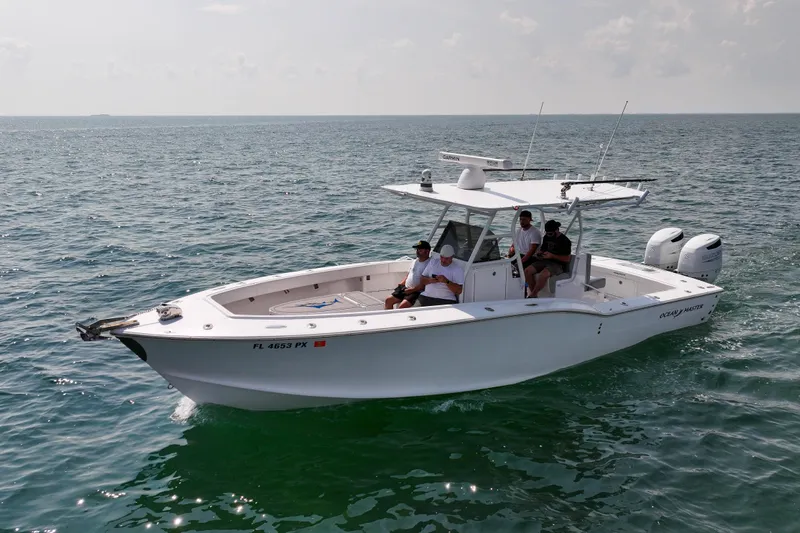  Yacht Photos Pics Ocean Master 31 Center Console boat, 1996 model, cruising on open water with passengers.