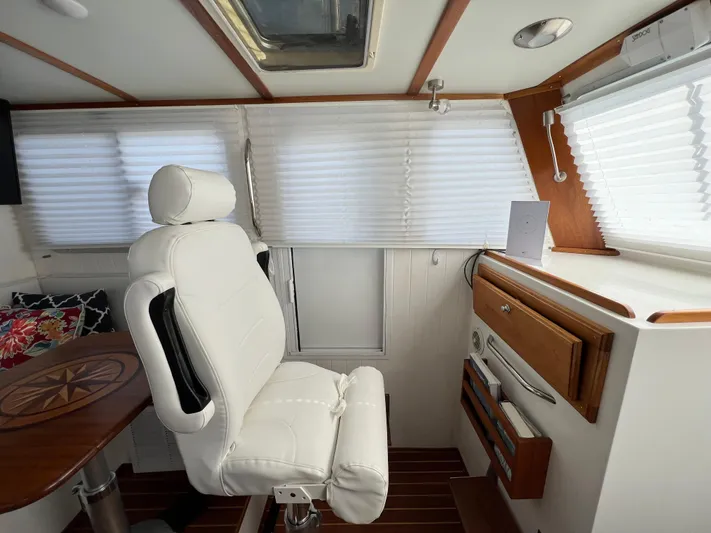 Idaho Red Yacht Photos Pics Interior of 2018 Great Harbour TT35 boat with white captain's chair and wooden accents.