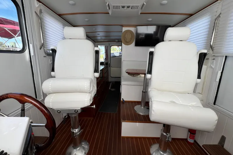 Idaho Red Yacht Photos Pics Interior of 2018 Great Harbour TT35 boat with white seating and wood flooring.