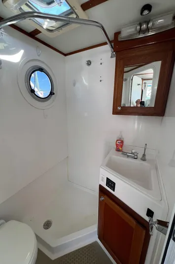 Idaho Red Yacht Photos Pics Bathroom interior of 2018 Great Harbour TT35 boat with shower, sink, and porthole.