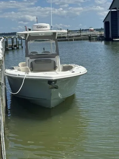  Yacht Photos Pics 2023 Key West 263 FS boat docked in calm waters under a partly cloudy sky.