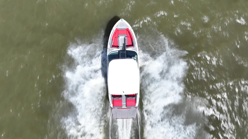  Yacht Photos Pics Aerial view of 2025 Regal LS9 boat speeding on water, creating white wake.