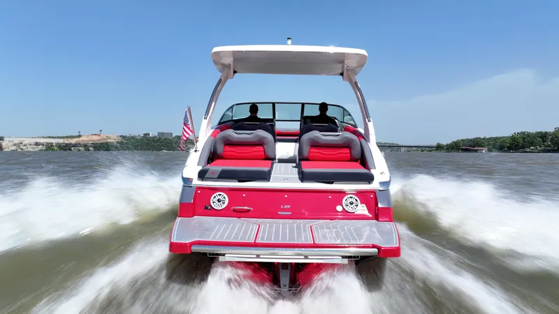  Yacht Photos Pics 2025 Regal LS9 boat cruising on a sunny day, rear view with wake.