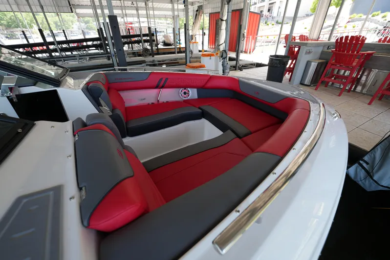  Yacht Photos Pics 2025 Regal LS9 boat interior with red and gray seating, docked under a canopy.